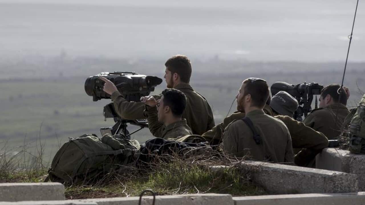 Israeli soldiers taking positions next to the Israeli-Syrian border