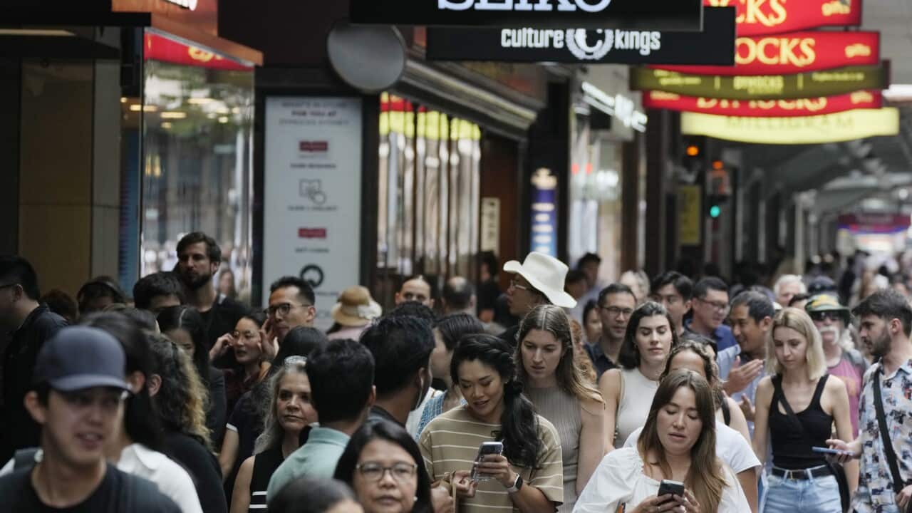 People walk past stores in central Sydney