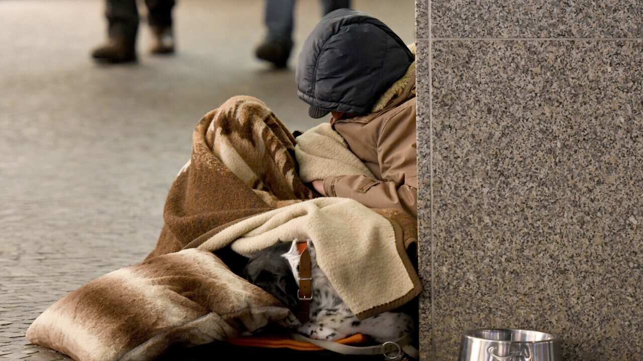 homeless man sleeping in the street, Freiburg, Feb. 14, 2018 | usage worldwide