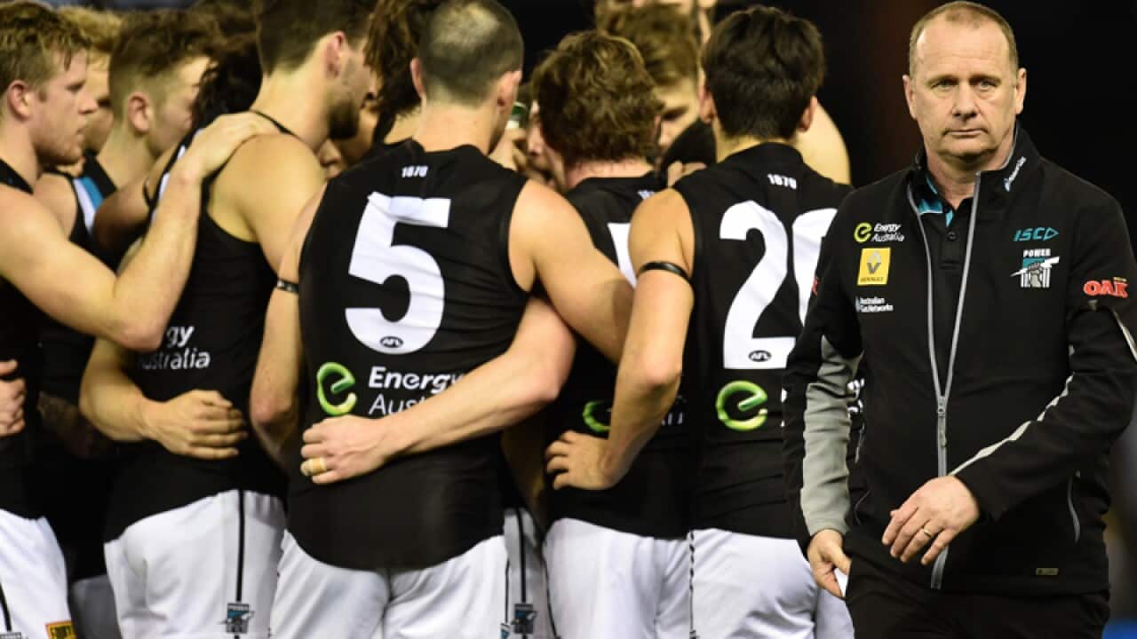 Port Adelaide coach Ken Hinkley (R) and his players