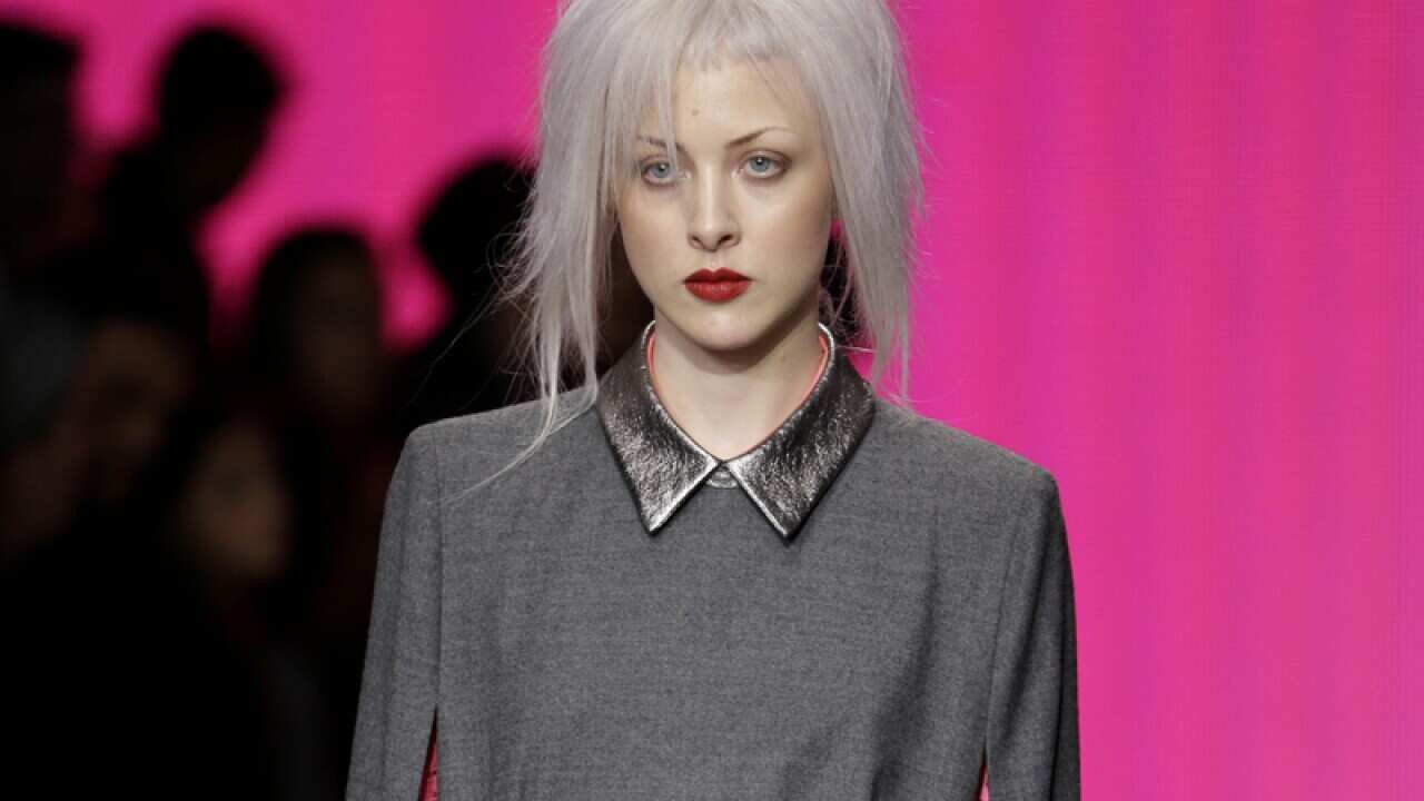 A model presents fashion from the Fall 2014 DNKY collection