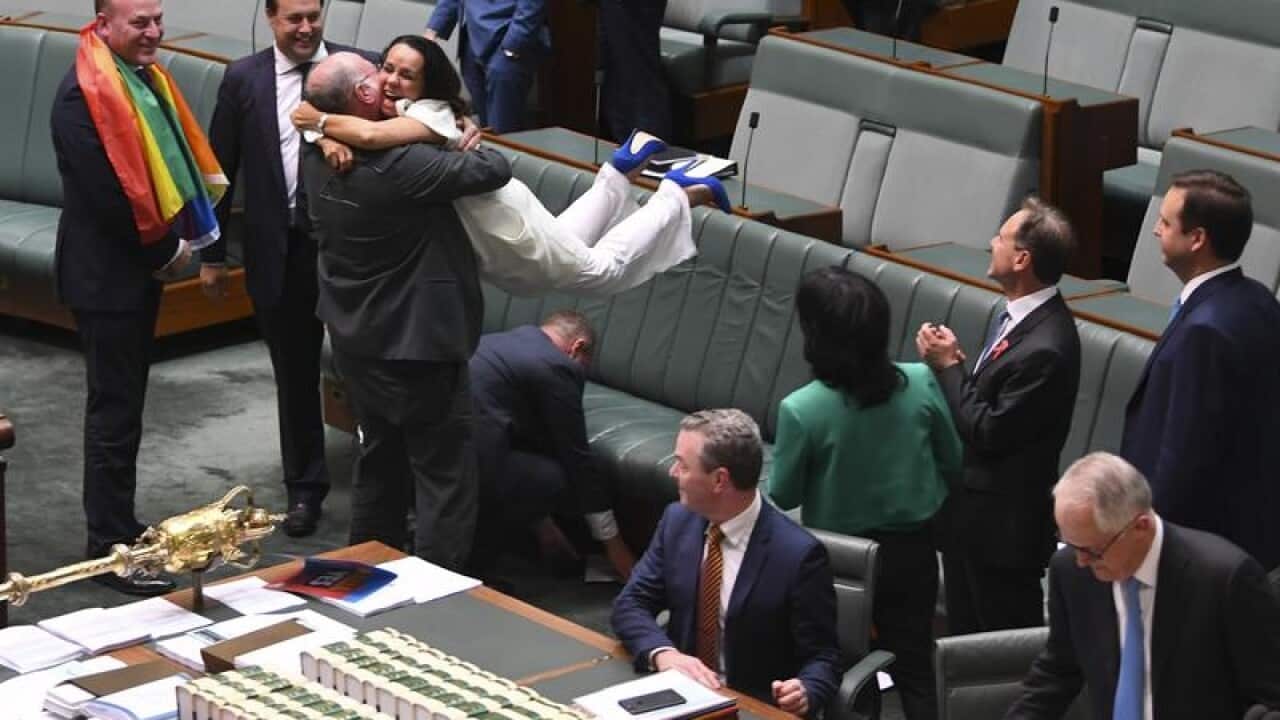 Liberal MP WarrenEntsch lifts up Labor MP Linda Burney