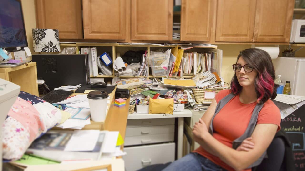woman sitting in messy office