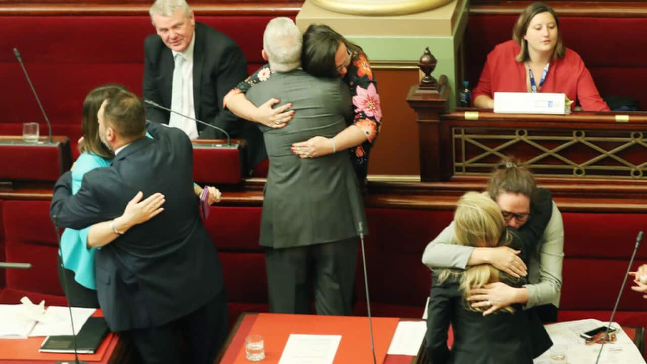 Victorian MPs hug after the assisted dying bill passed in the Legislative Council