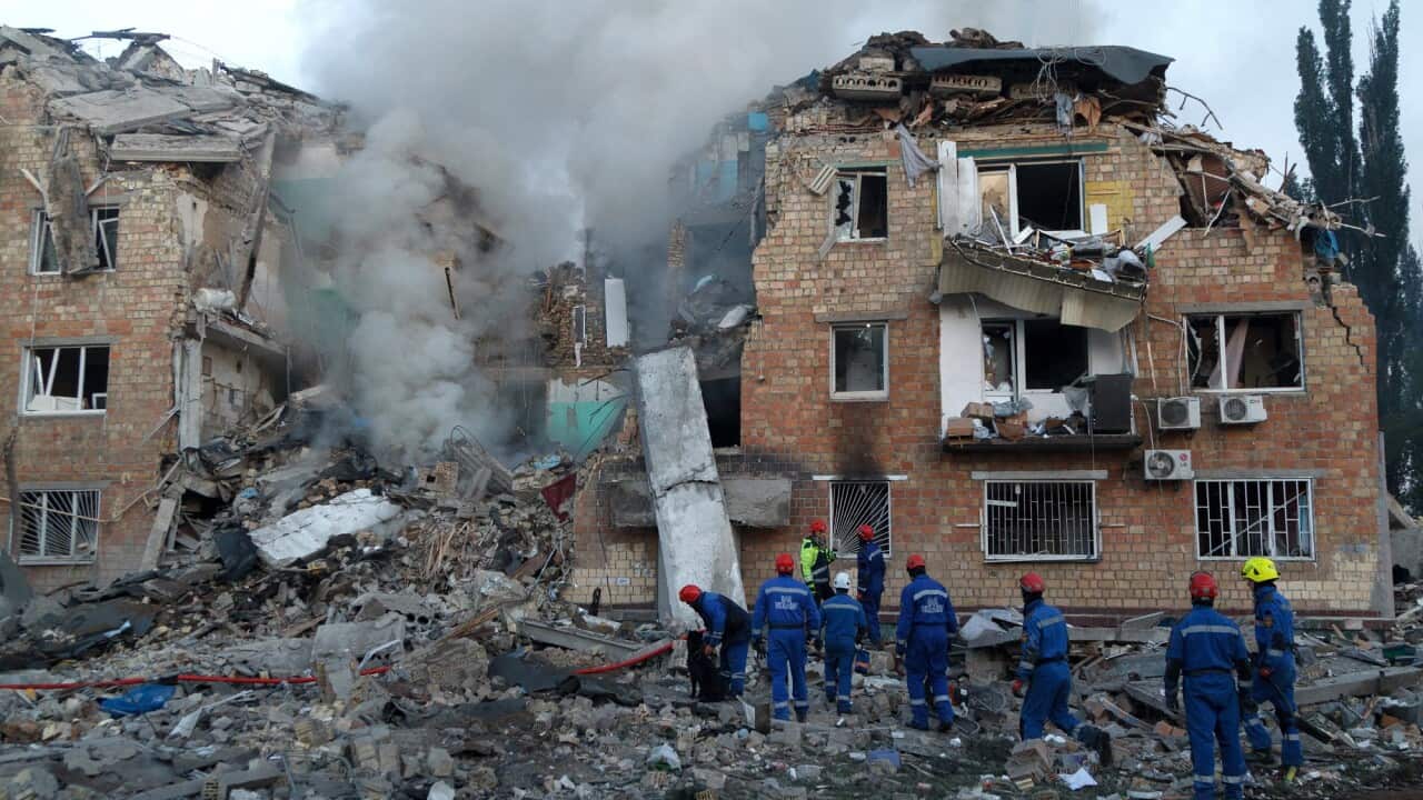 An apartment rubble is now reduced to rubble. Rescue crew can be seen moving around the site.