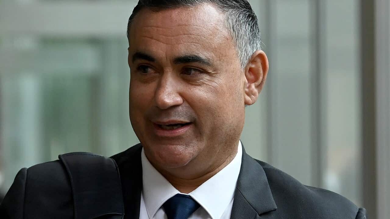 A man speaking as he walks.