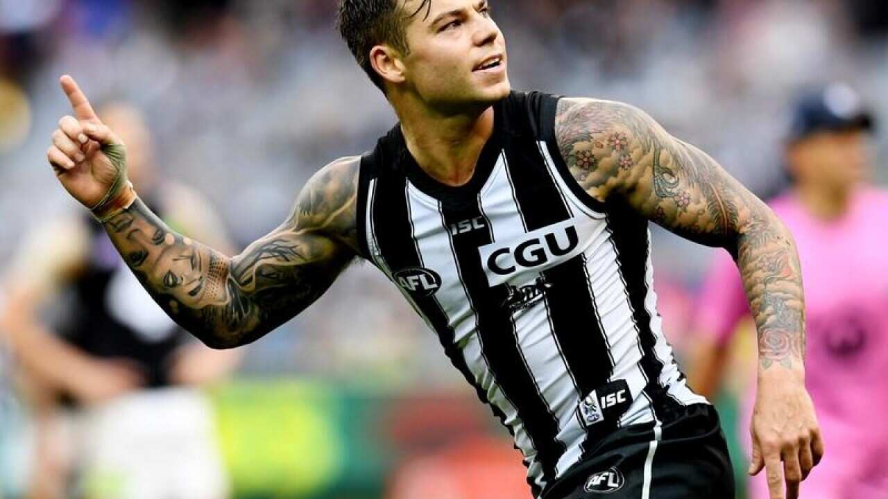 Jamie Elliott of the Magpies gestures