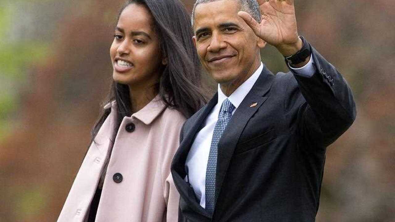 In this April 7, 2016 file photo, President Barack Obama and his daughter Malia, walk across the South Lawn of the White House in Washington