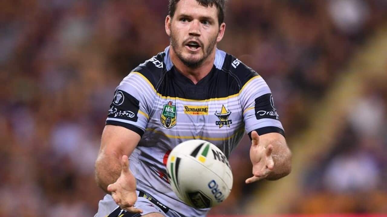 Lachlan Coote of the Cowboys passes the ball.
