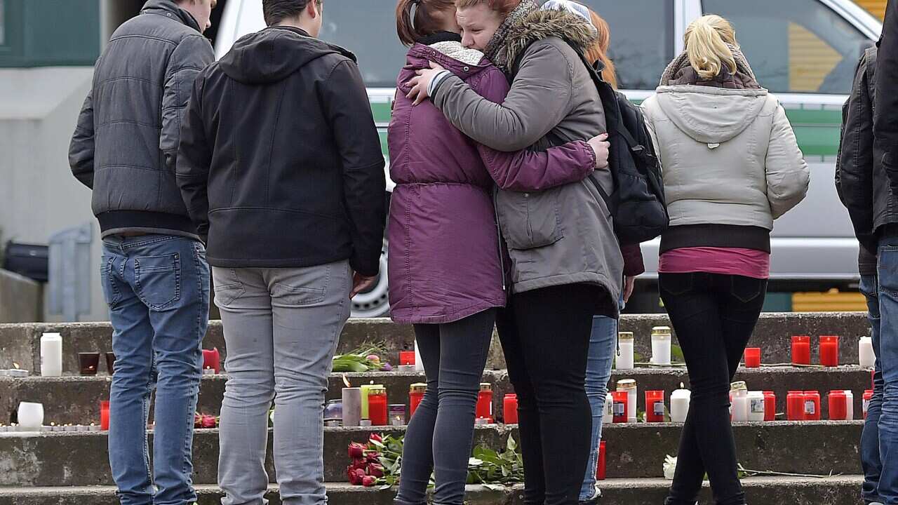 School children mourn for their school mates  in front of the Joseph-Koenig Gymnasium in Haltern, western Germany Tuesday, March 24, 2015.(AP Photo/Martin Meissner)