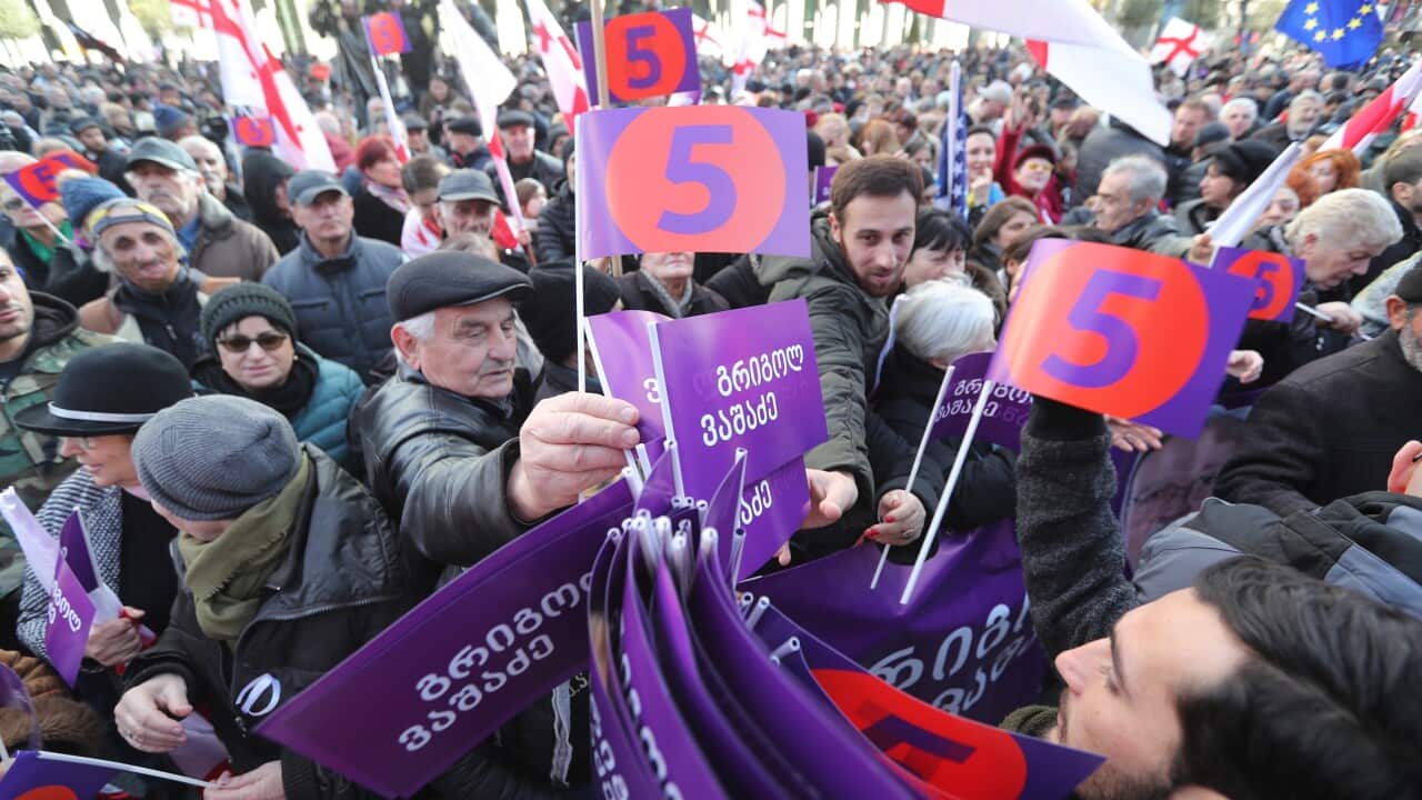 Supporters of Georgian opposition presidential candidate Grigol Vashadze attend a protest rally in Tbilisi, Georgia.