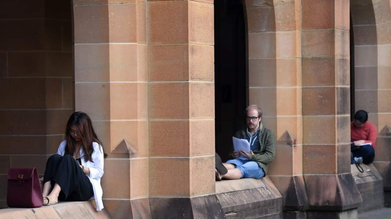 Students read at the Quadrangle of the University of Sydney