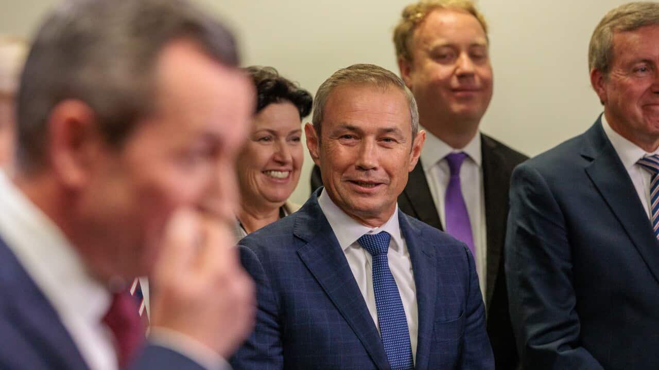 Western Australian Premier Mark McGowan speaks during a press conference while deputy premier Roger Cook looks on.