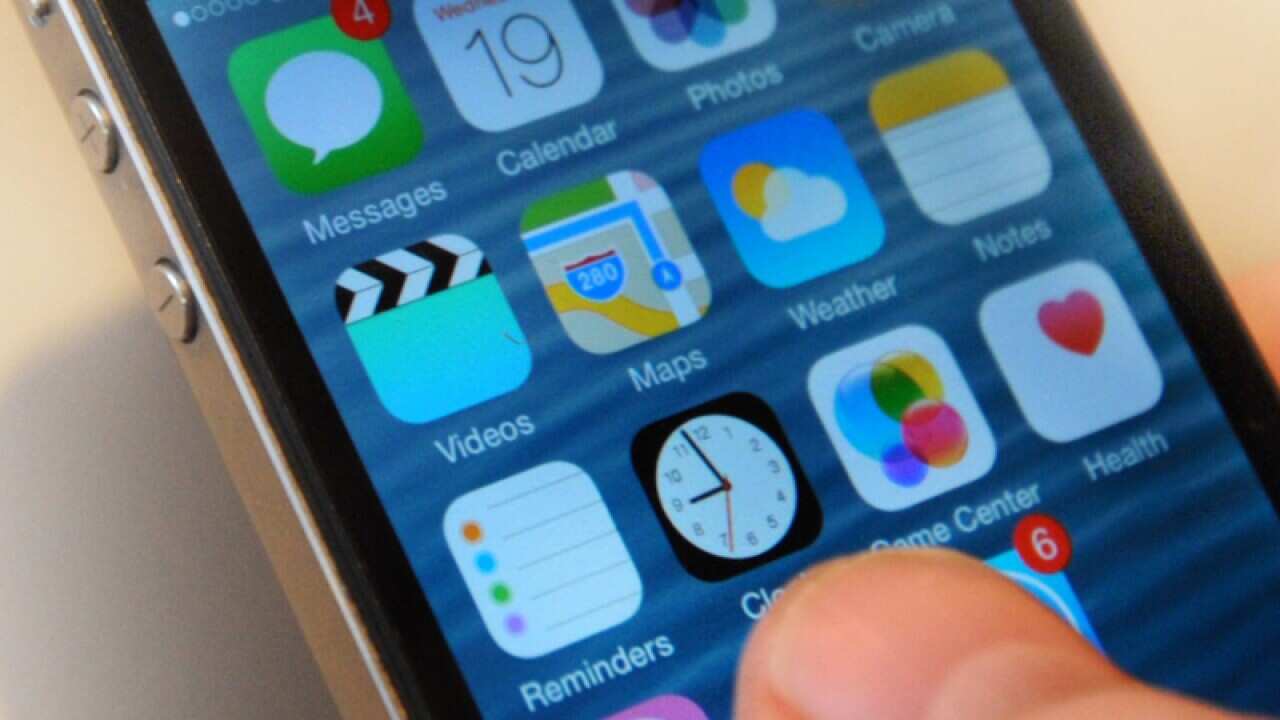 A generic stock photo of a man using an Apple iPhone