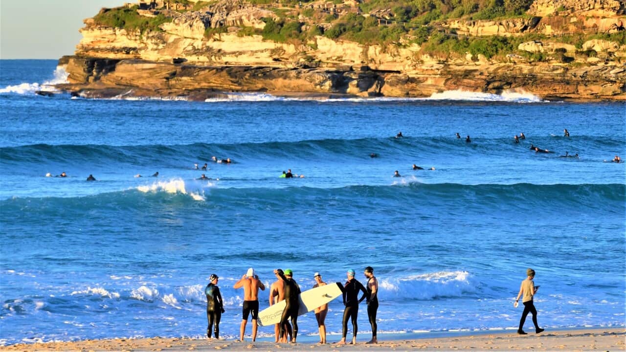 Surfers and swimmers are seen at Bondi Beach in Sydney, Saturday, June 26, 2021.
