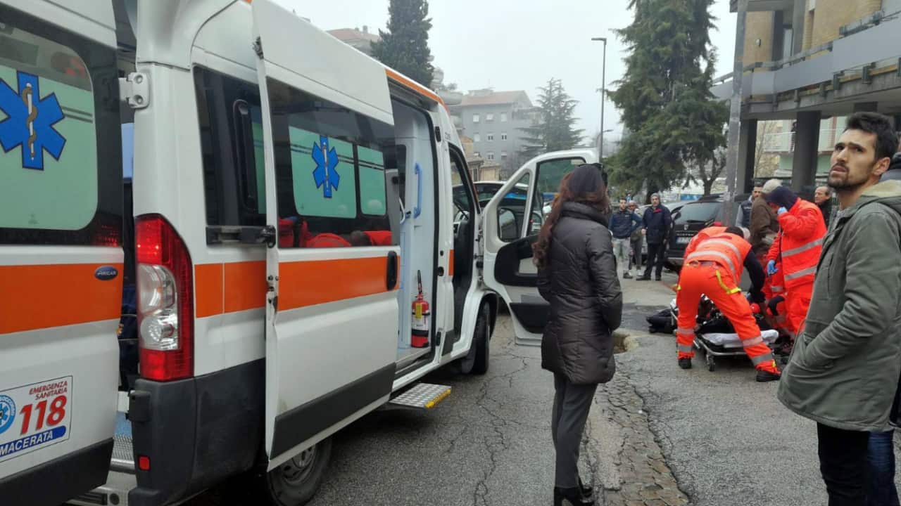 Paramedics treat an injured person that was shot from a passing vehicle in Macerata, Italy.