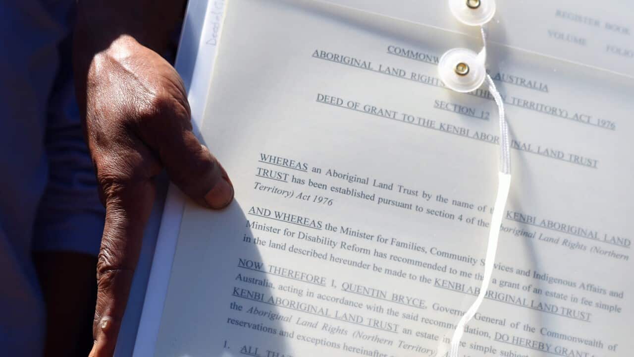 Traditional owner Raylene Singh holds the land deed during the Kenbi Native land claim
