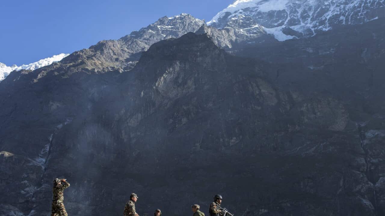 Army rangers on watch in front of a landslide in Langtang valley