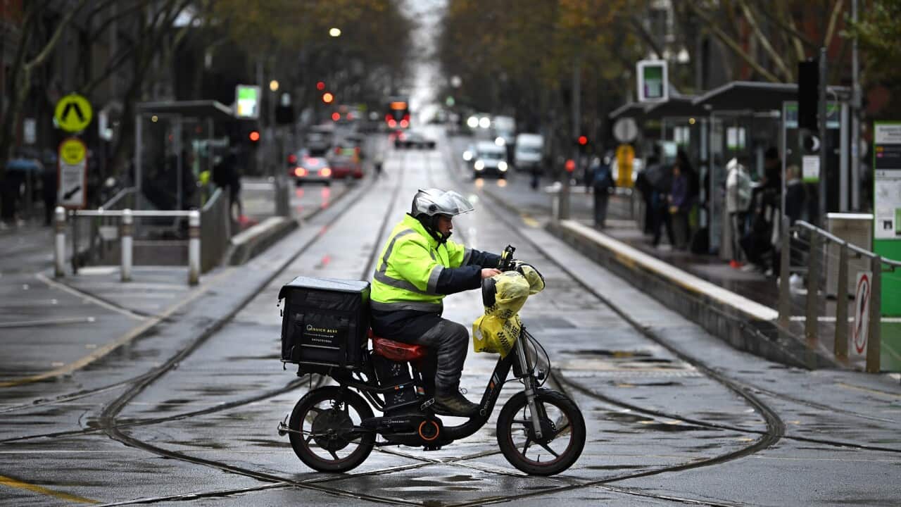 A delivery driver is seen riding e-bike in Melbourne (AAP)