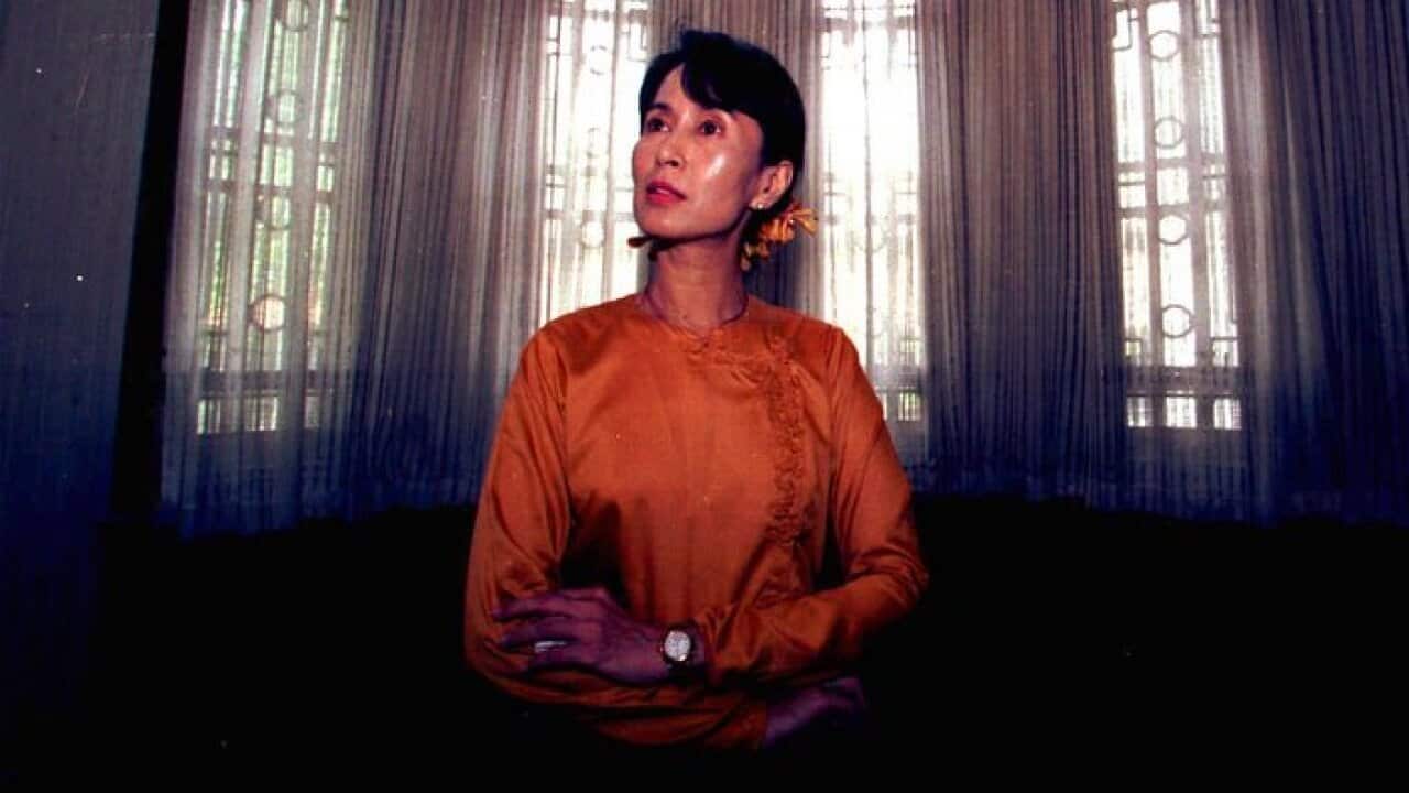 Pro-Democracy leader Aung San Suu Kyi sits at the window of her residence during an interview in Rangoon, Burma.