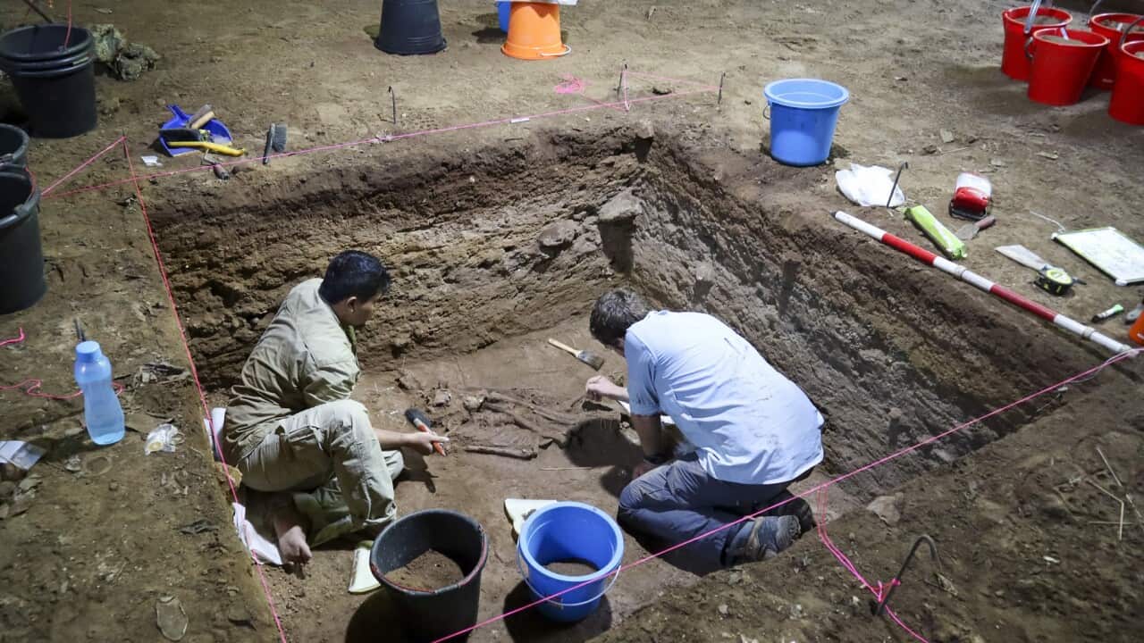 Dr Tim Maloney and Andika Priyatno work at the site in a cave in East Kalimantan, Borneo