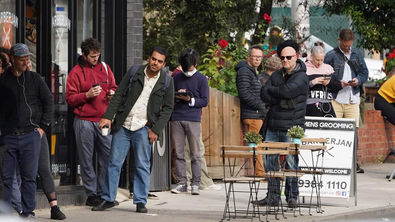 People are seen queuing outside a Centrelink office in Brunswick, Melbourne.