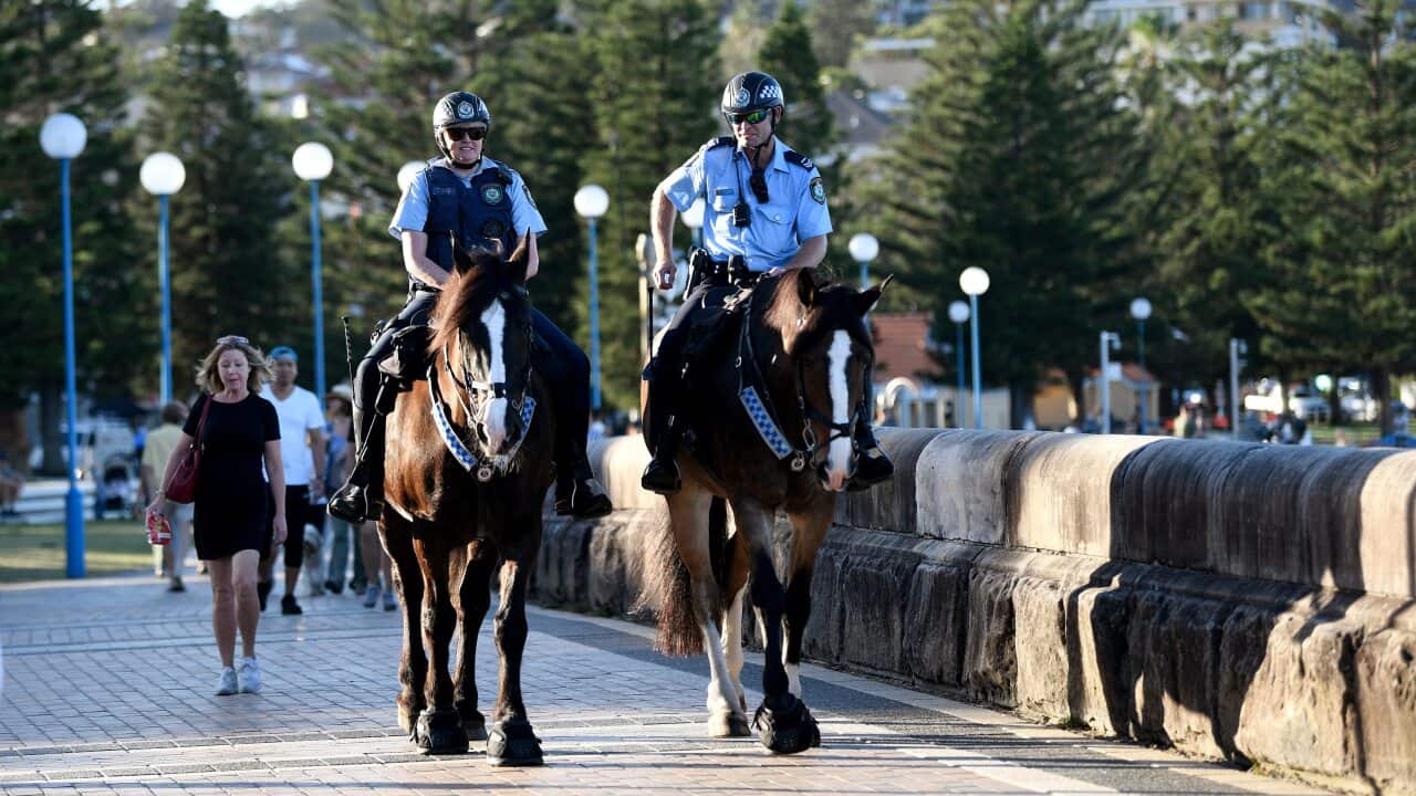 Mounted police are seen patrolling a closed Coogee Beach in Sydney on Friday.