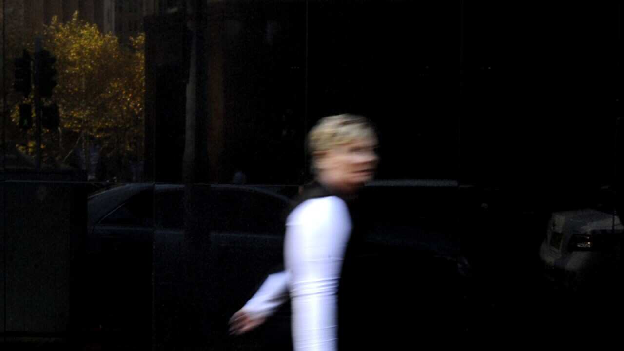 A pedestrian walks past the Reserve Bank of Australia