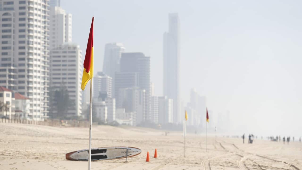 Smoke haze from local bushfires obscures the skyline on the beach at Surfers Paradise on the Gold Coast, Thursday, September 5, 2019. (AAP Image/Tim Marsden) NO ARCHIVING