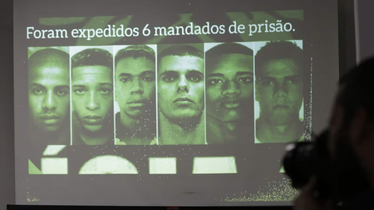 Photos of gang rape suspects are displayed on a screen