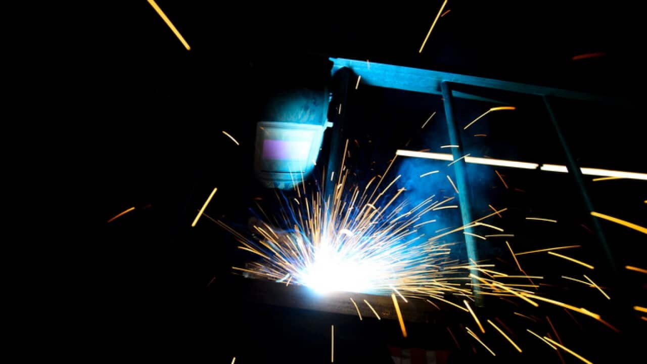 A welder fabricates a steel structure at an iron works facility in Ottawa, Ontario
