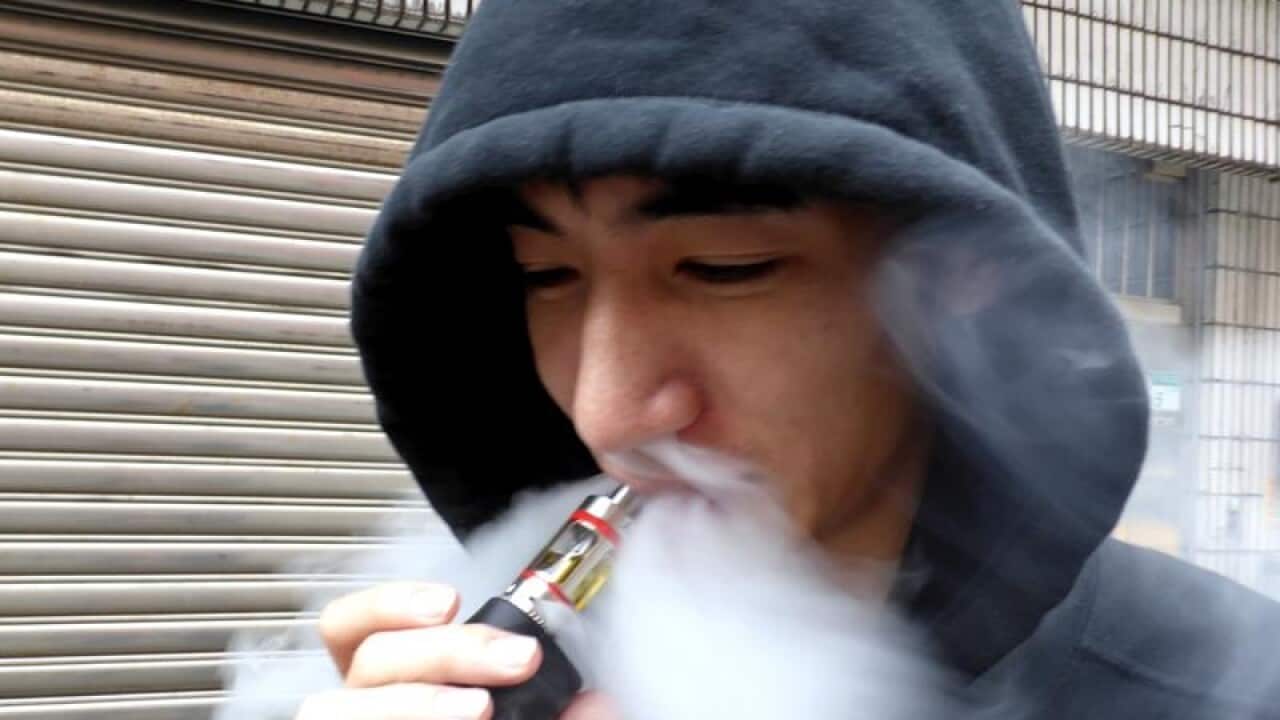 A man smokes an electronic cigarette.