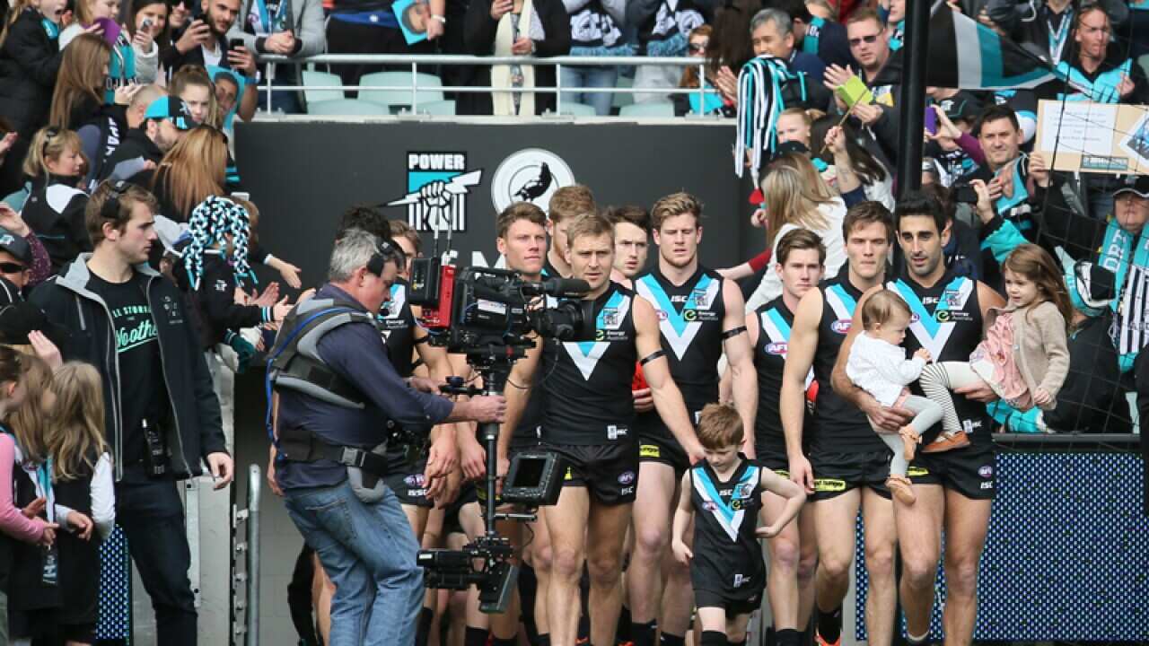 Port Adelaide make their way onto the field before a match.