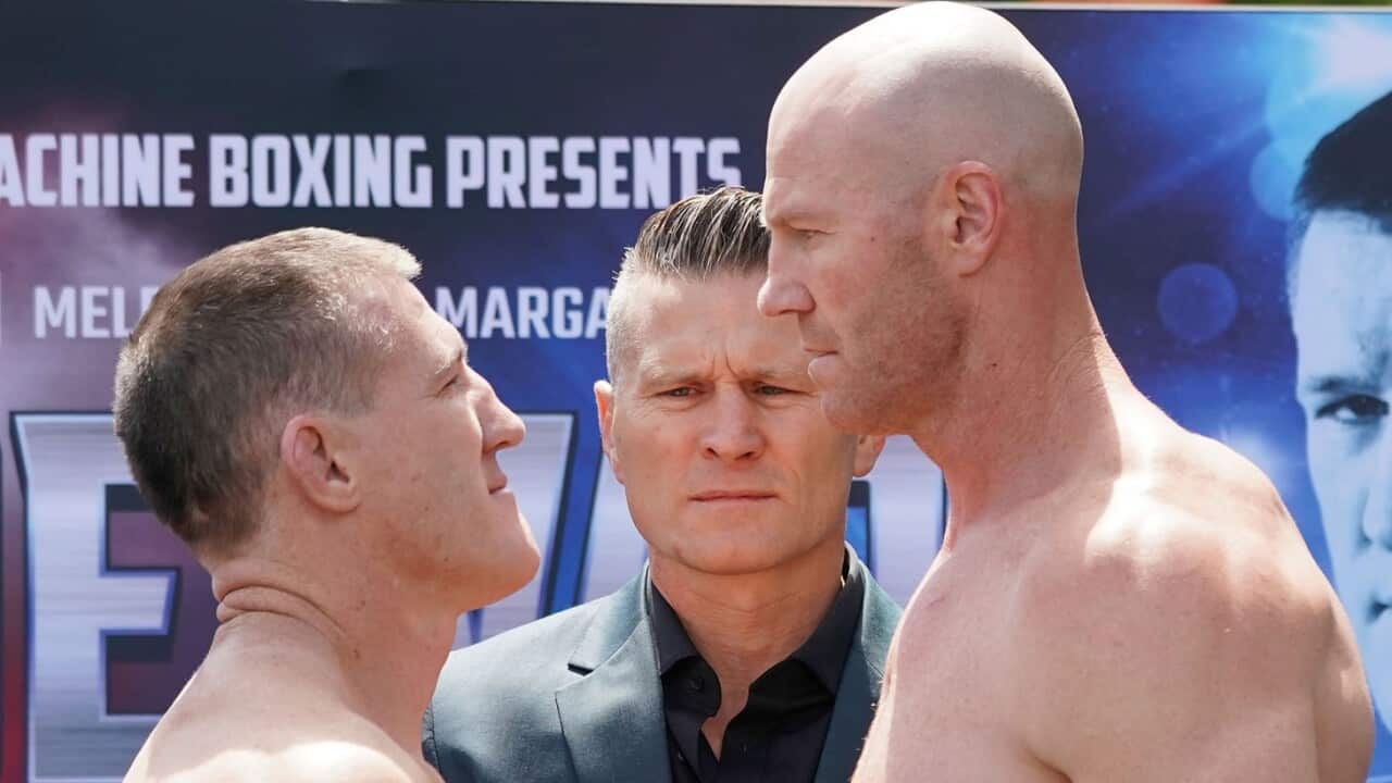Paul Gallen (left) and Barry Hall face off as promoter Danny Green looks on during an official weigh-in