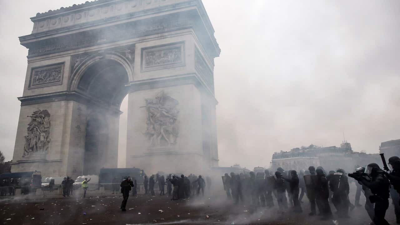 Riot police clash with protesters.