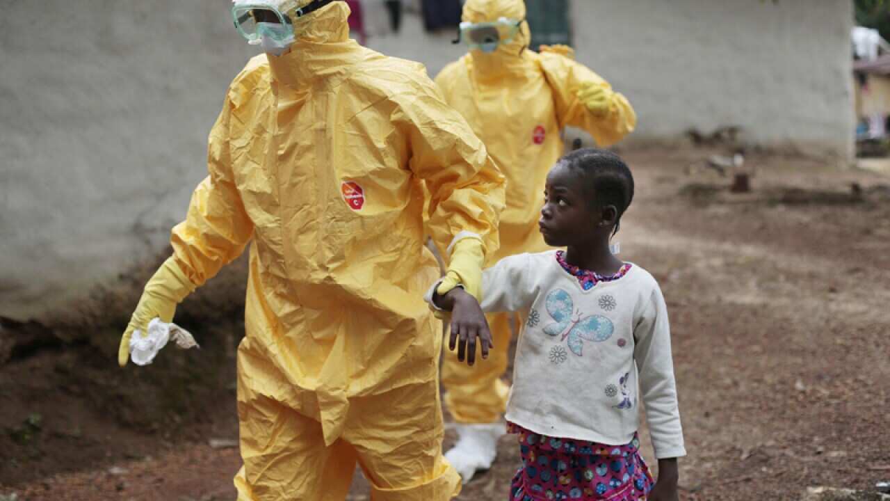 Nowa Paye, 9, is taken away after showing signs of Ebola in Liberia