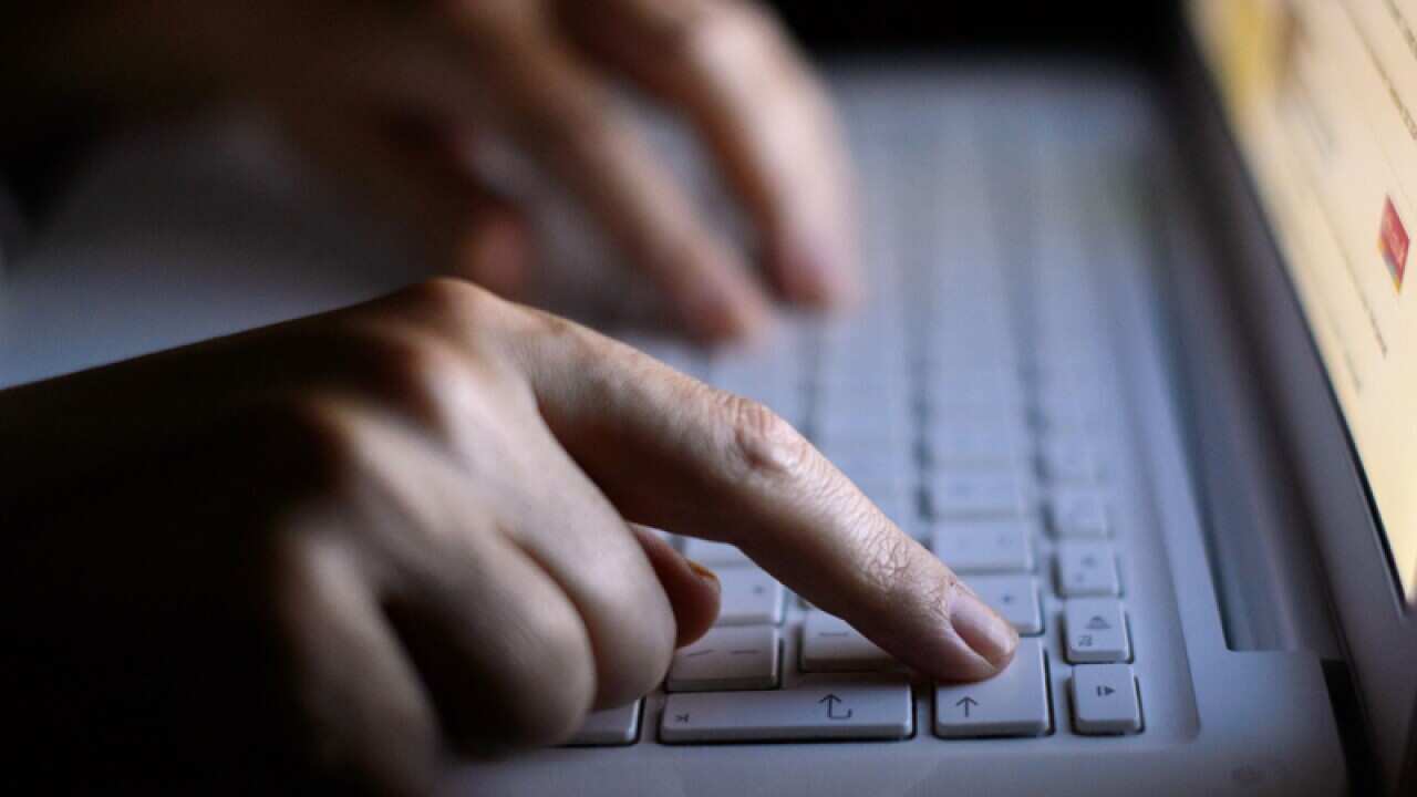 Someone using a laptop keyboard.