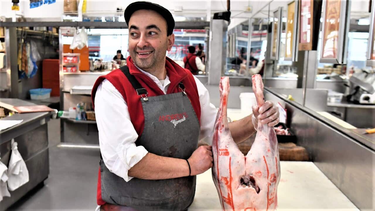 Butcher George Vourvahakis holds a leg of an Australian lamb at his store in the Melbourne suburb of Yarraville.