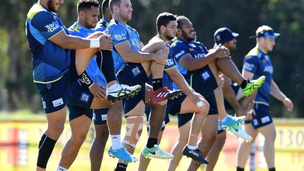 Players stretch during the Gold Coast Titans training session