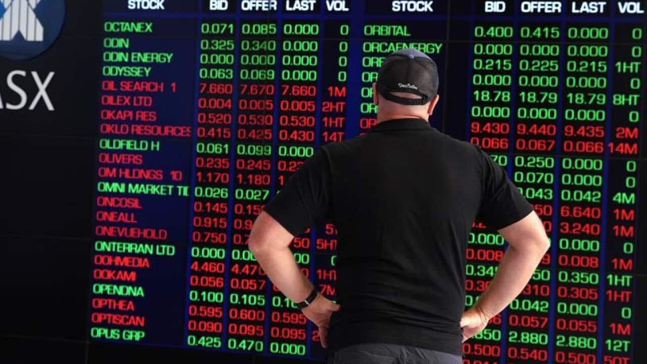 Man watches ASX board.