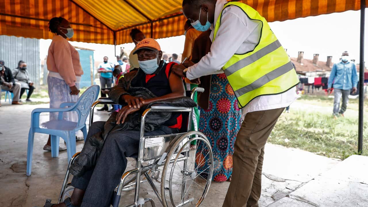 A Kenyan man receives a dose of the AstraZeneca coronavirus vaccine donated by Britain, at the Makongeni Estate in Nairobi.