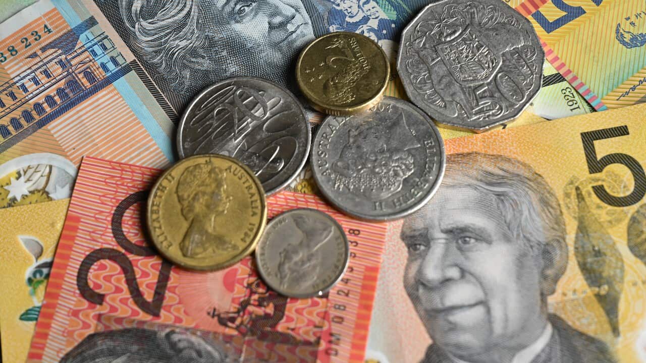 A close up of Australian bank notes and coins