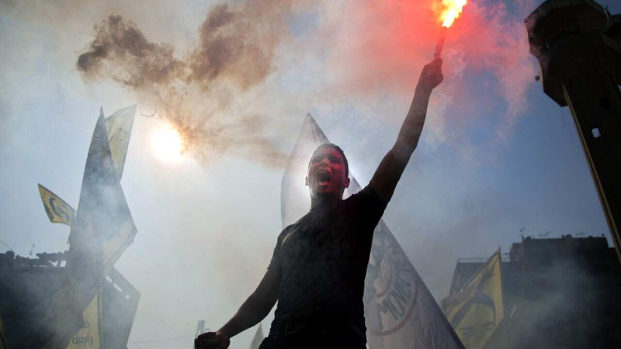 A man holds a flare during a protest in Cairo