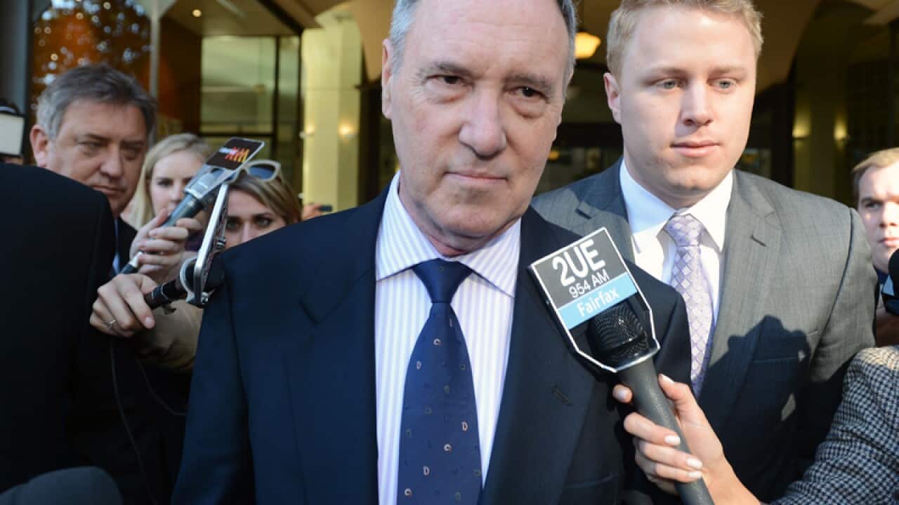 Robert Hughes leaves the Downing Centre Courts in Sydney