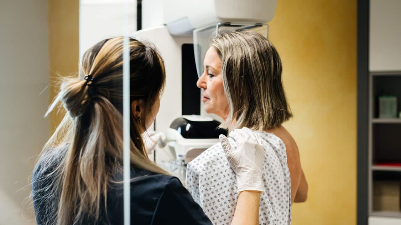 Nurse Assisting Patient During Mammogram