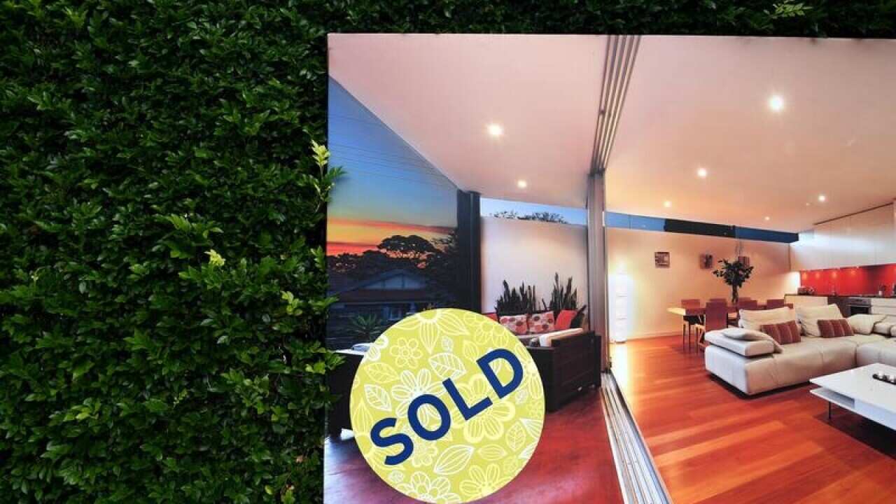 A for sale sign displayed in front of a house