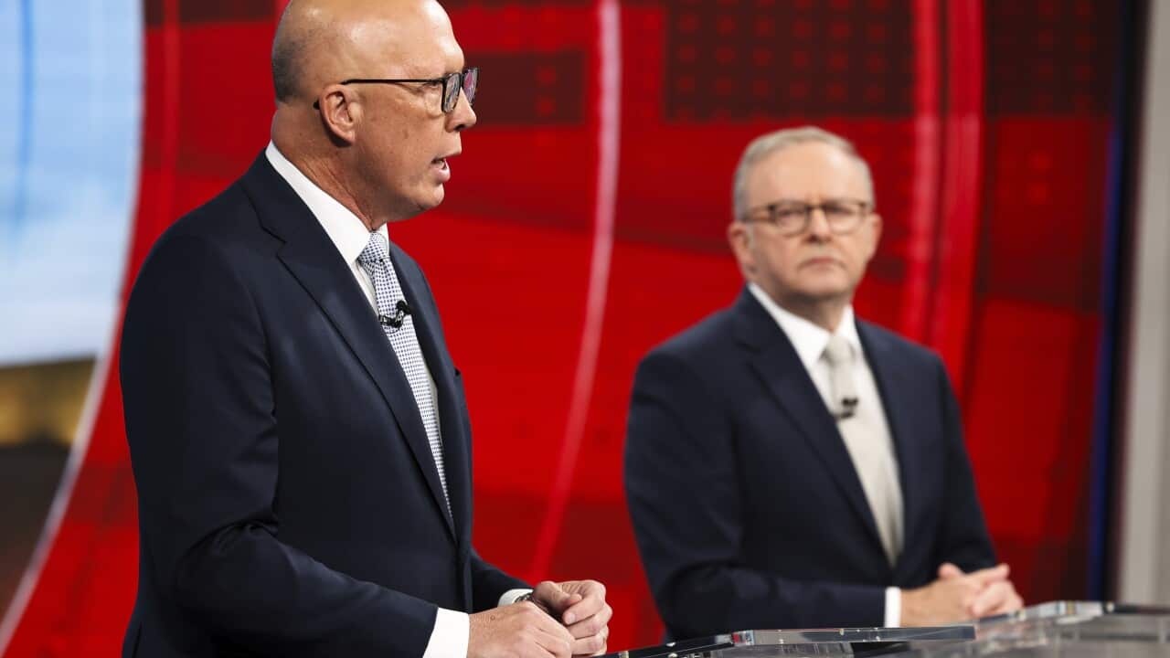 Opposition leader Peter Dutton speaks while Prime Minister Anthony Albanese listens during a debate.