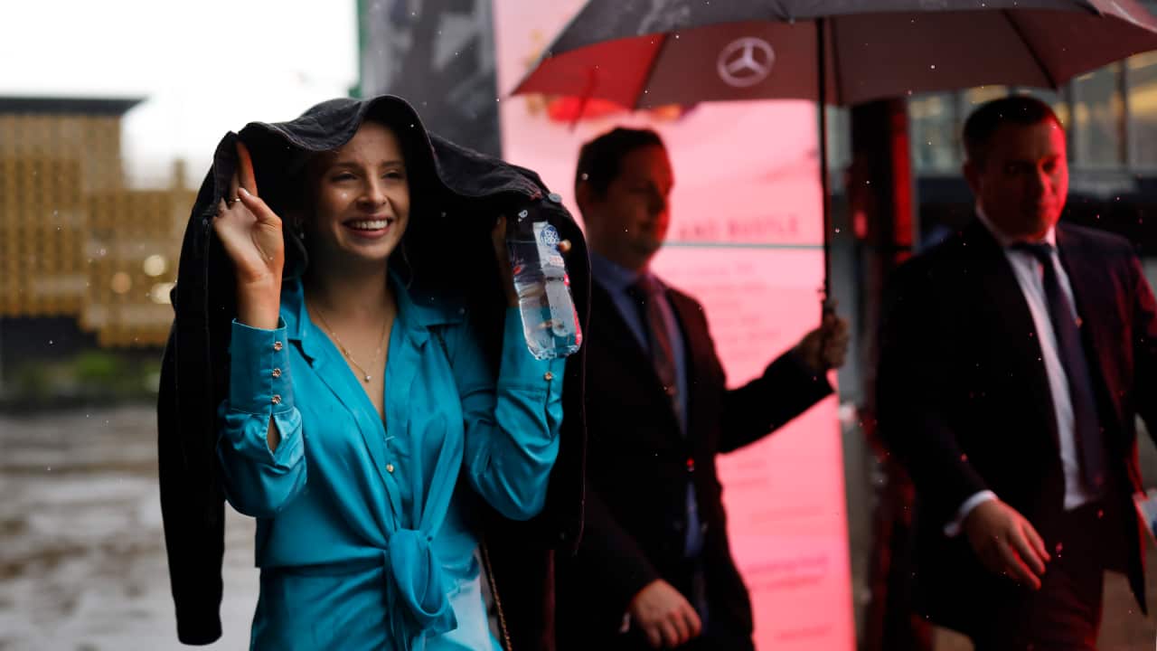 Racegoers leave the track after the races were postponed because of the rain during Sydney Racing at Royal Randwick Racecourse on October 08, 2022 in Sydney, Australia.