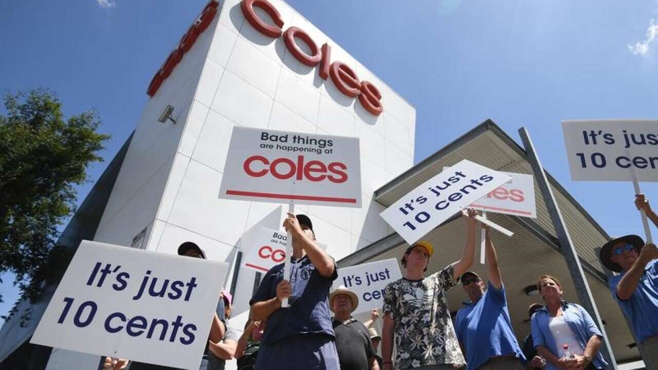 Dairy farmers protest in Brisbane outside a Coles.