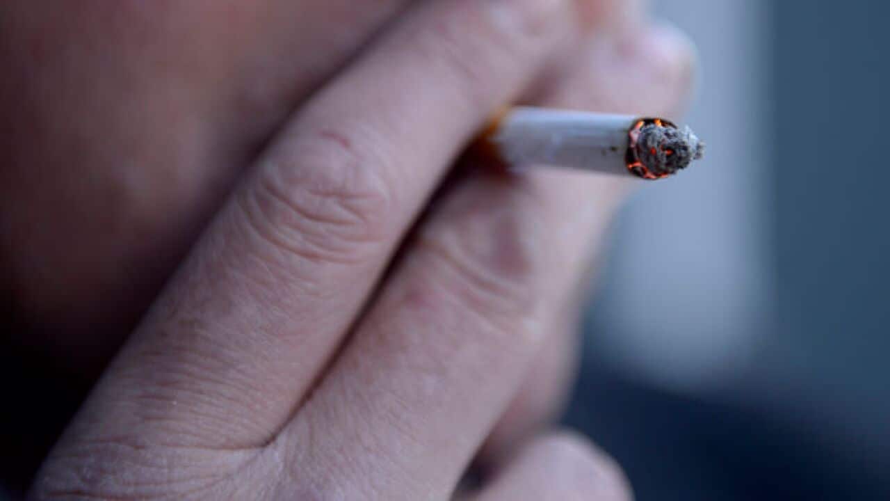 man smoking a cigarette